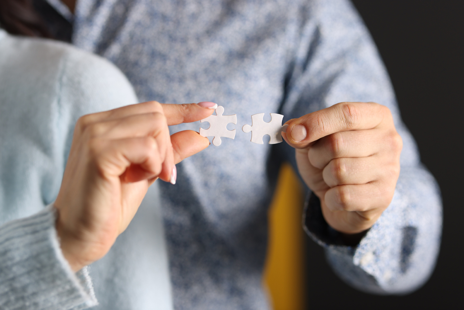 Man and Woman Connect White Puzzles Closeup